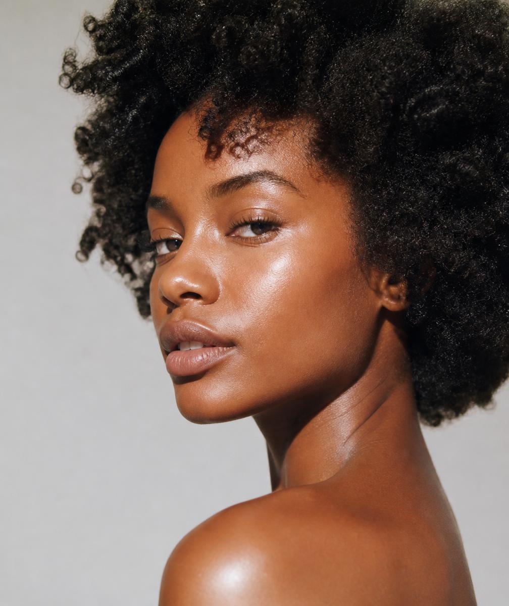Close-up portrait of a woman with glowing, radiant skin